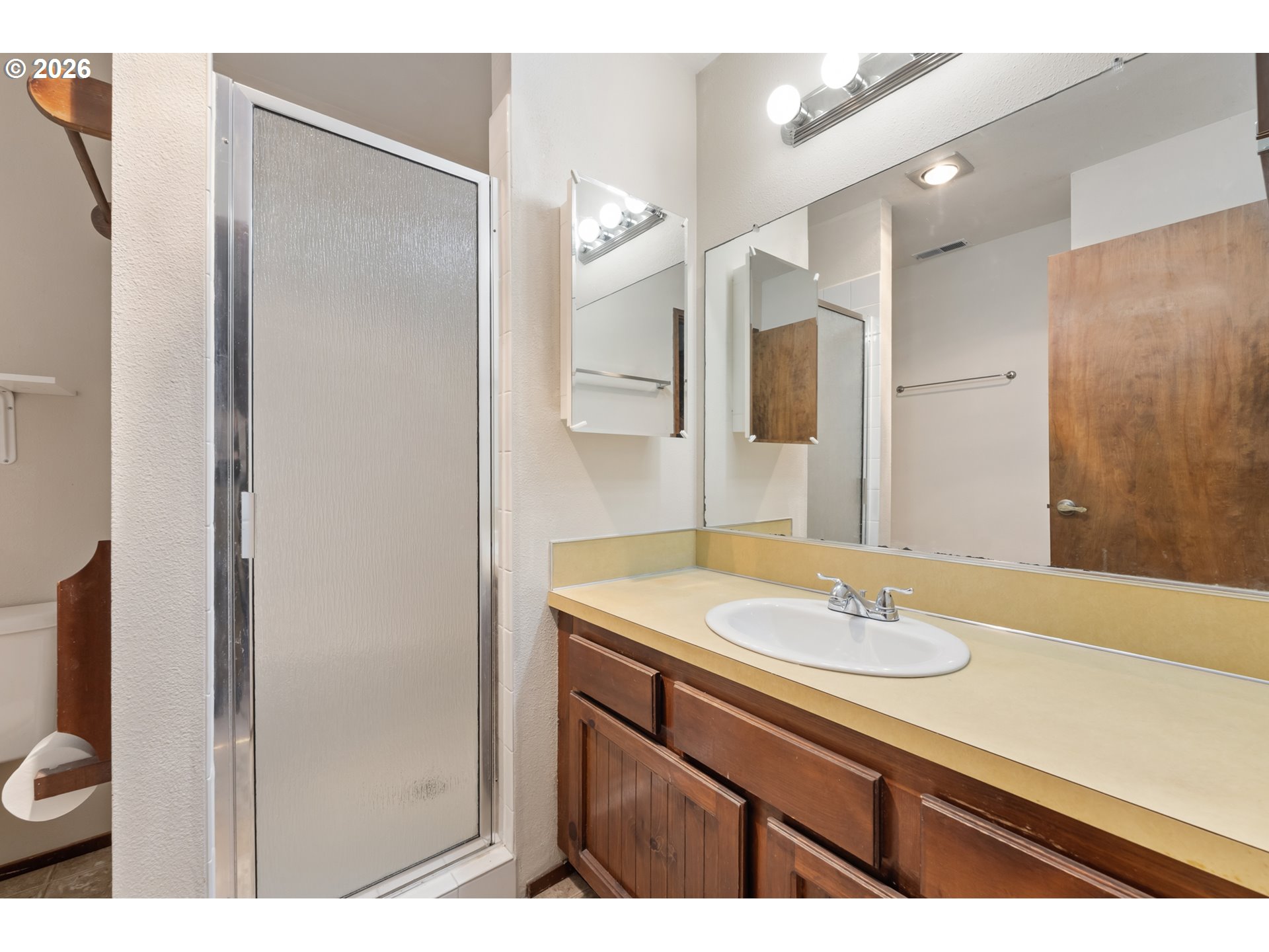 14807 Southwest 106th Avenue Portland, OR 97224 - Photo 23 of 37 a bathroom with a sink and a mirror
