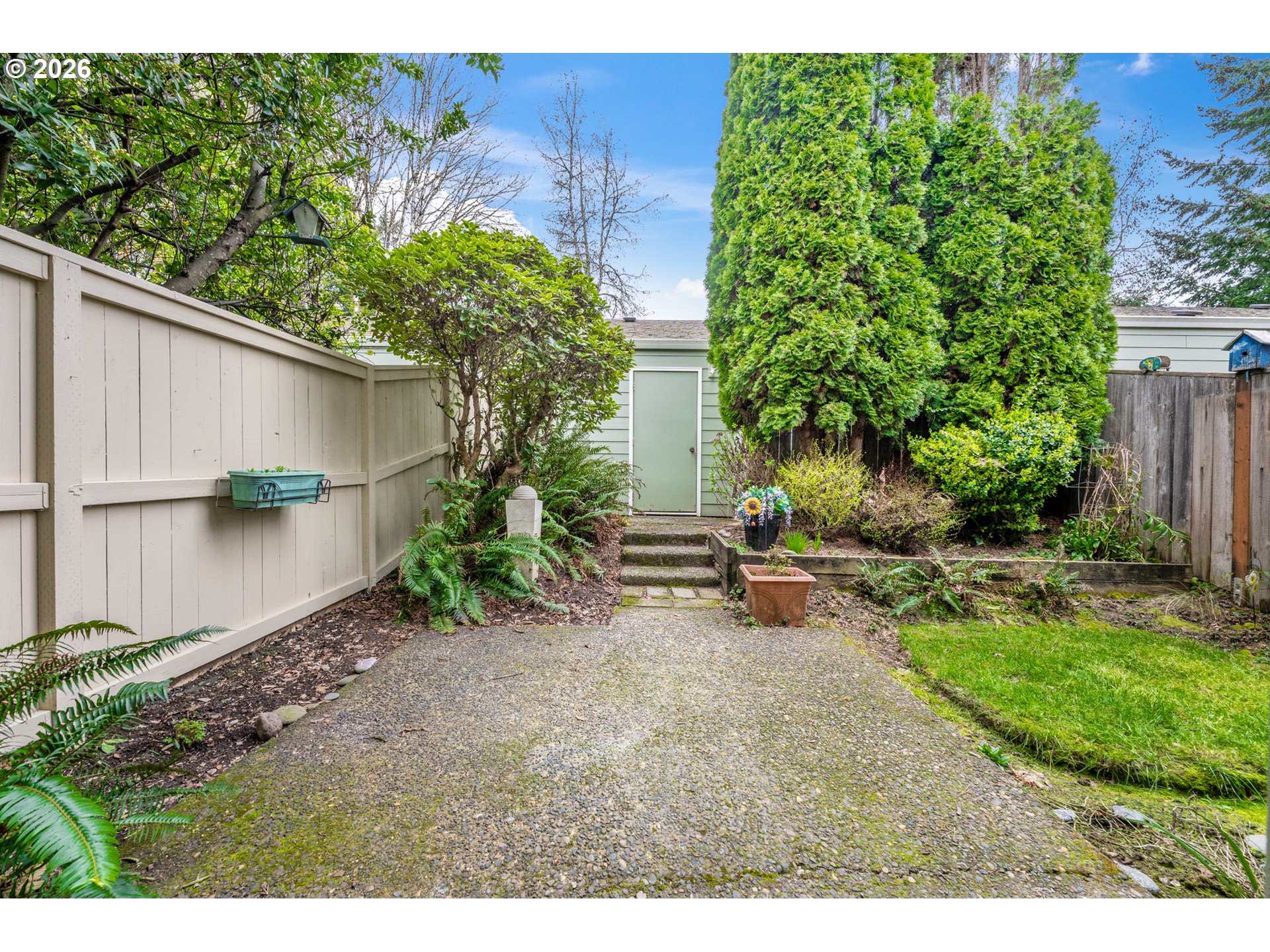 14807 Southwest 106th Avenue Portland, OR 97224 - Photo 27 of 37 a backyard of a house with a garden and plants