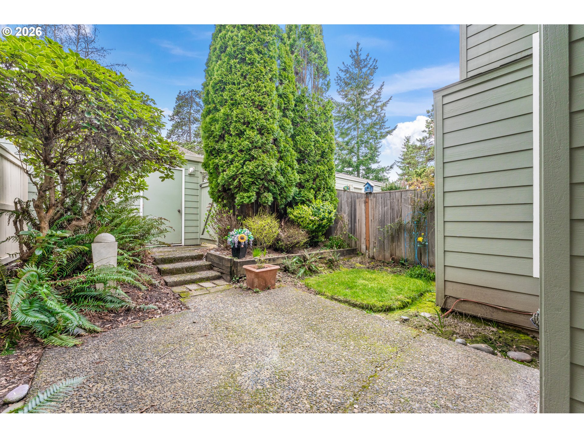 14807 Southwest 106th Avenue Portland, OR 97224 - Photo 28 of 37 a backyard of a house with plants and outdoor seating
