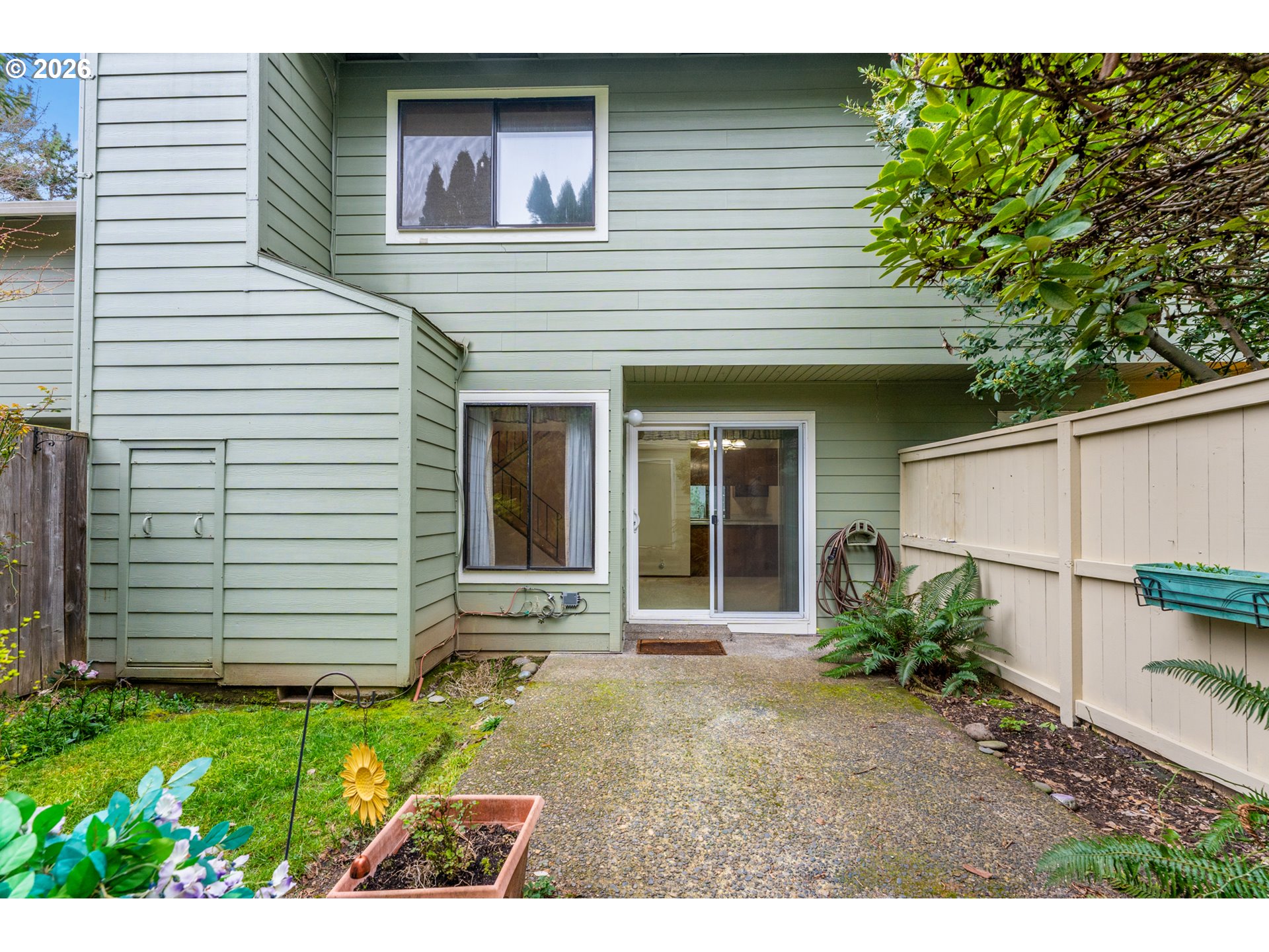 14807 Southwest 106th Avenue Portland, OR 97224 - Photo 30 of 37 a view of a backyard with a chair and potted plants