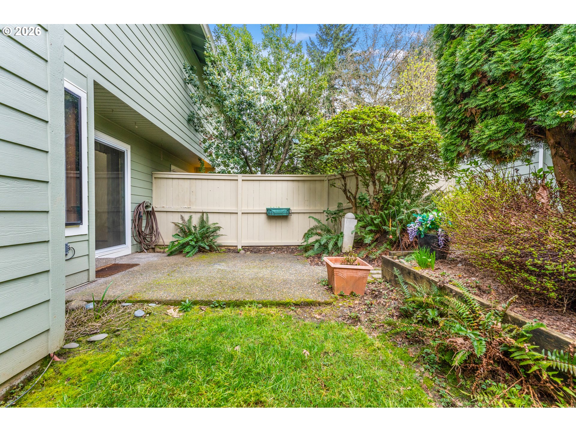 14807 Southwest 106th Avenue Portland, OR 97224 - Photo 31 of 37 a view of a backyard with plants and large trees