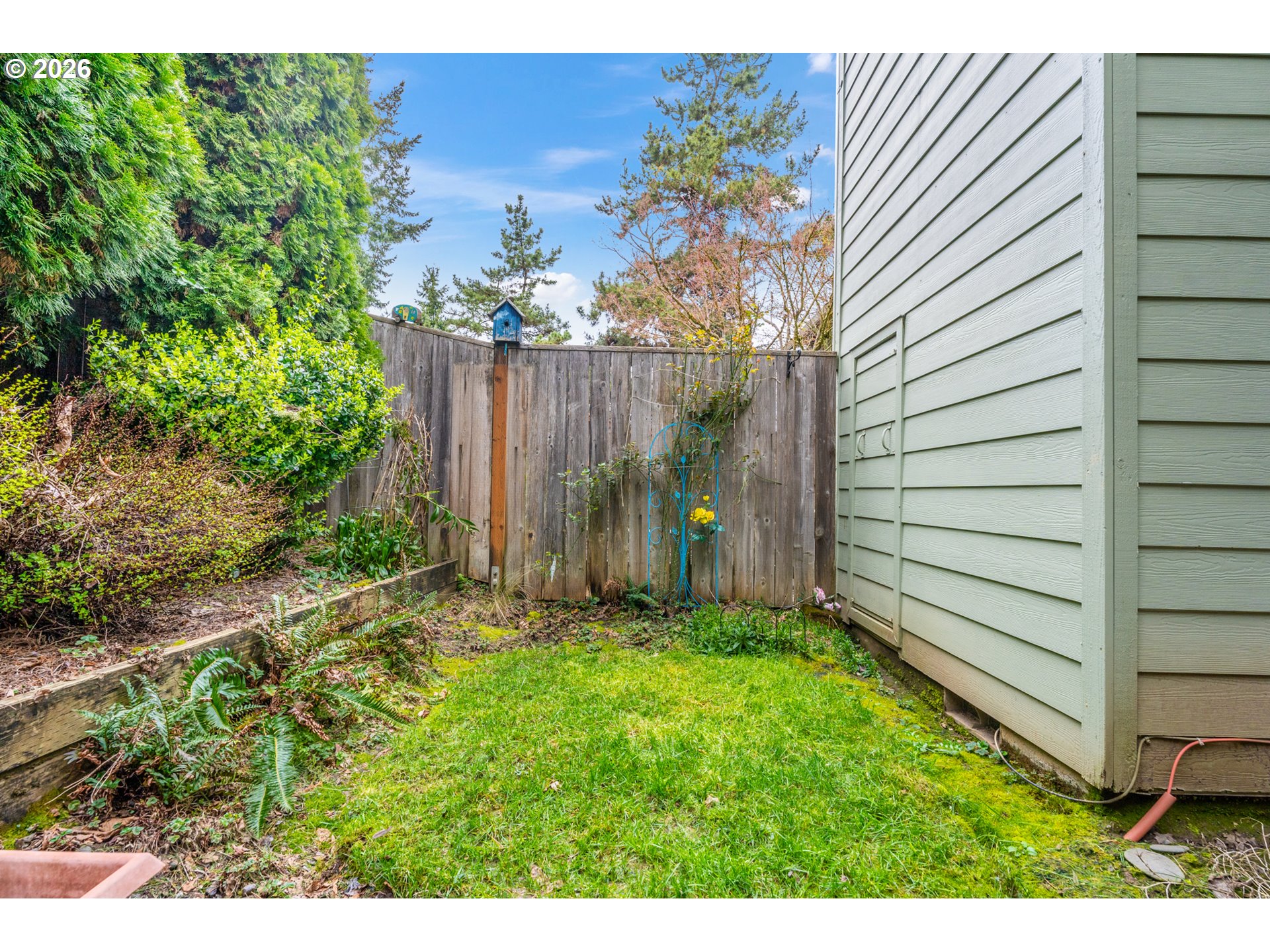 14807 Southwest 106th Avenue Portland, OR 97224 - Photo 32 of 37 a view of backyard with potted plants and wooden fence