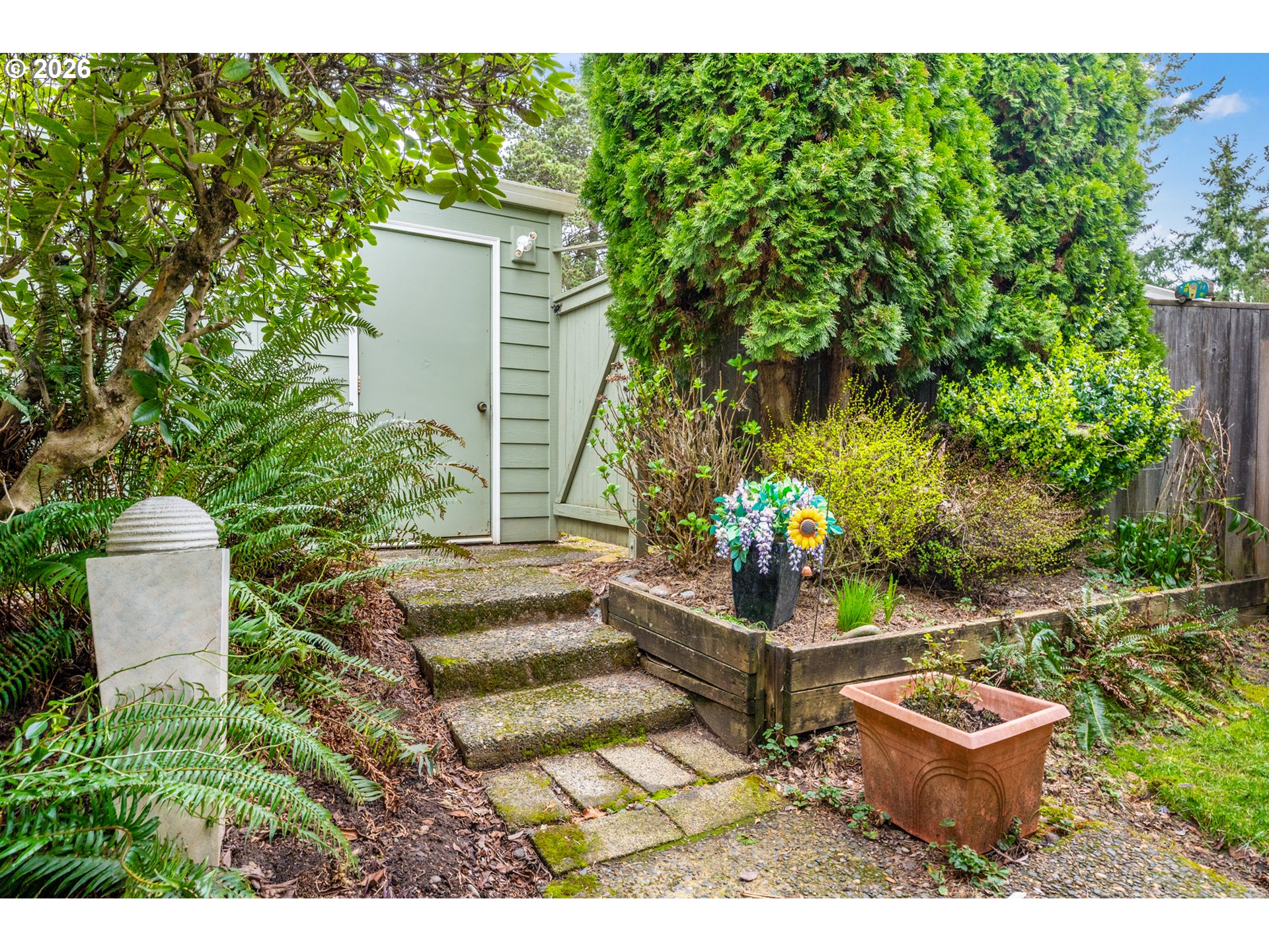 14807 Southwest 106th Avenue Portland, OR 97224 - Photo 33 of 37 a view of a backyard with chair and potted plants