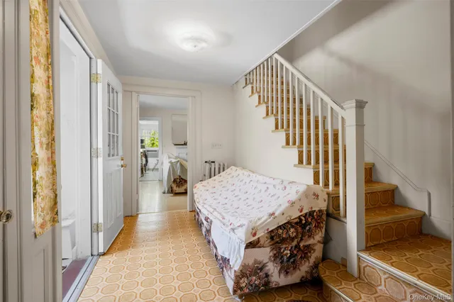 a living room with a bed and a walk in closet