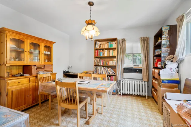a dining room with furniture a flat screen tv and a window