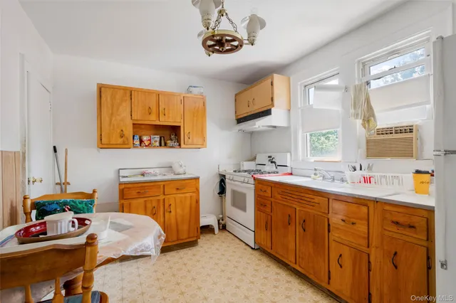 a kitchen with stainless steel appliances a sink stove and cabinets