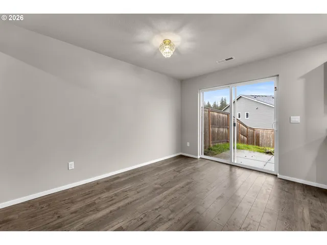 a kitchen with stainless steel appliances a refrigerator a stove top oven and a wooden floor