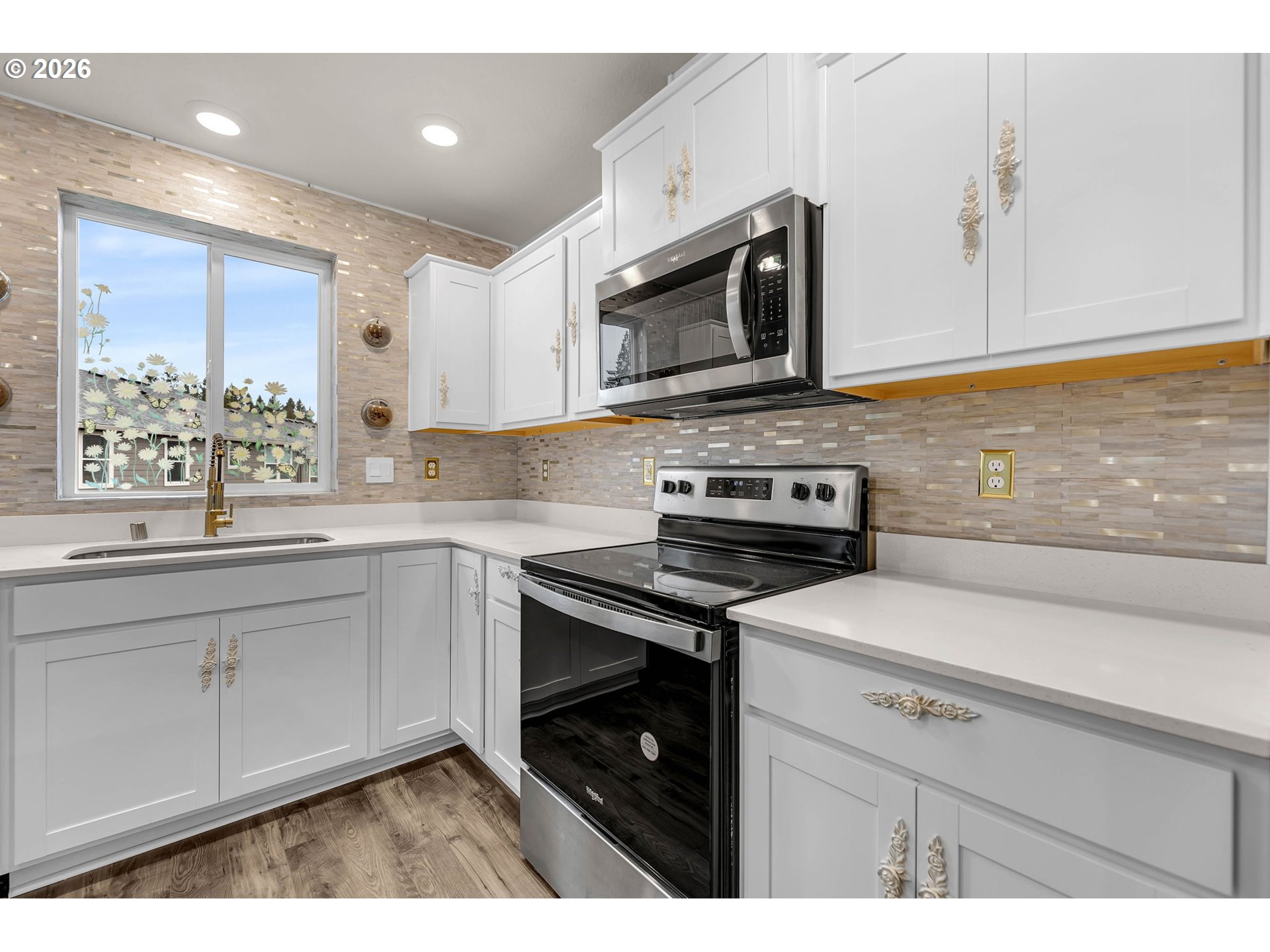 2933 North 3rd Way Ridgefield, WA 98642 - Photo 10 of 37 a kitchen with stainless steel appliances a stove microwave and sink