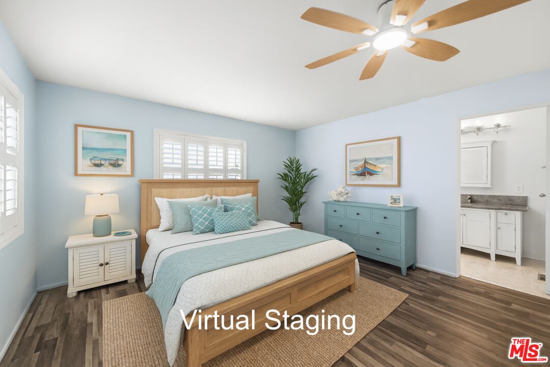 29500 Heathercliff Road, Unit 170 Malibu, CA 90265 - Photo 14 of 38 a bedroom with a large bed and a chandelier