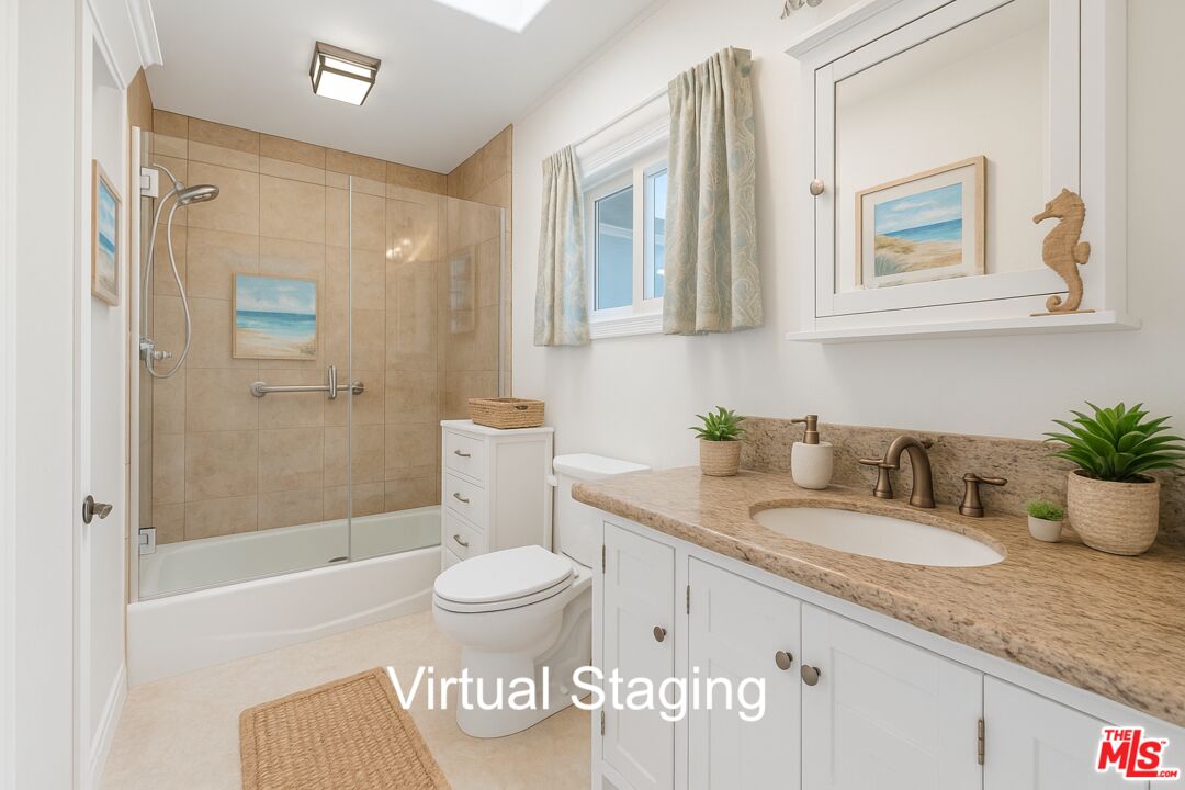 29500 Heathercliff Road, Unit 170 Malibu, CA 90265 - Photo 15 of 38 a bathroom with a granite countertop sink and a mirror
