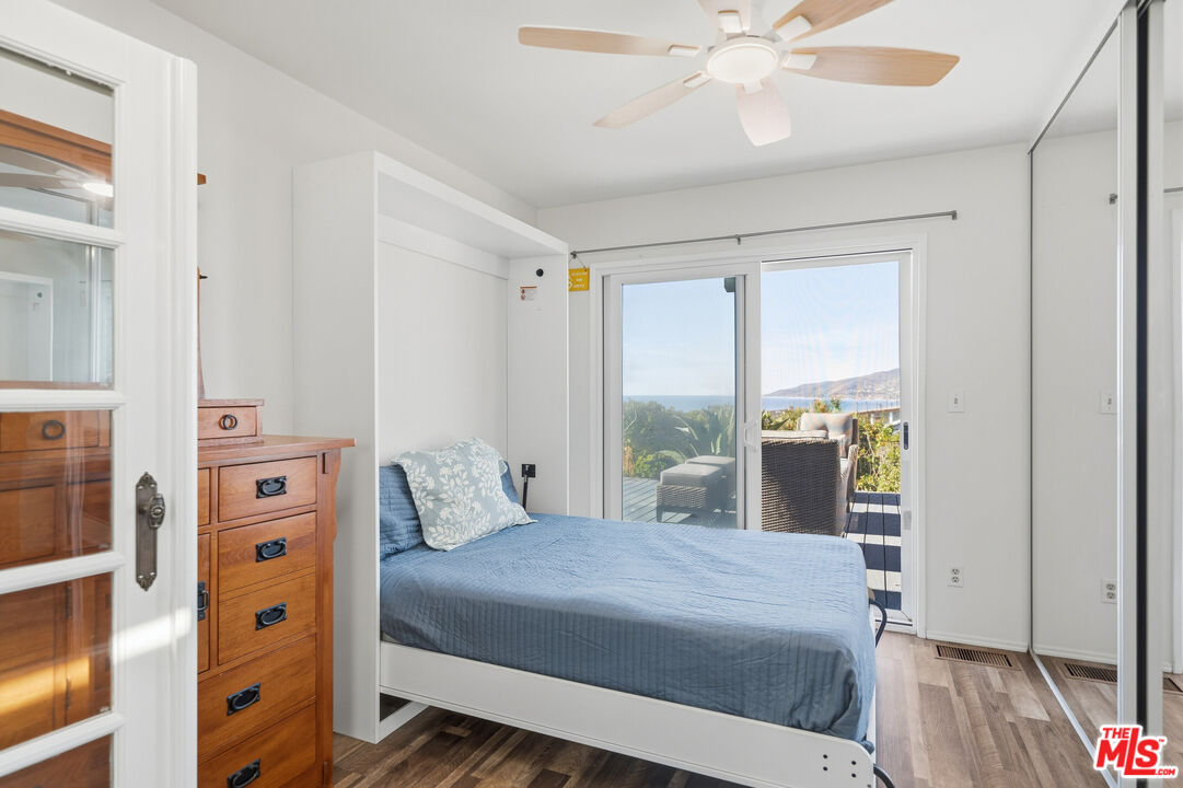 29500 Heathercliff Road, Unit 170 Malibu, CA 90265 - Photo 17 of 38 a bedroom with a large bed and a window