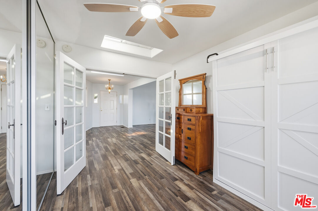 29500 Heathercliff Road, Unit 170 Malibu, CA 90265 - Photo 18 of 38 a room with wooden floor closet and chandelier fan