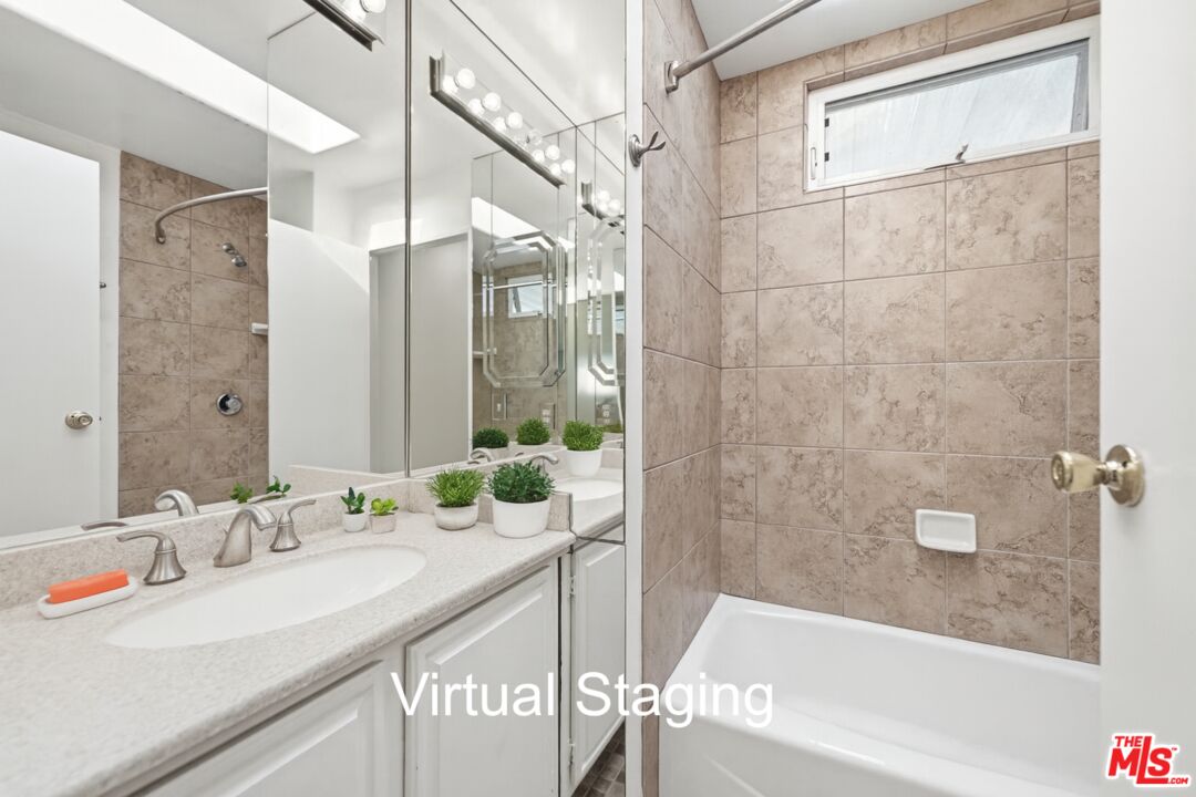 29500 Heathercliff Road, Unit 170 Malibu, CA 90265 - Photo 19 of 38 a bathroom with a granite countertop sink and a bathtub