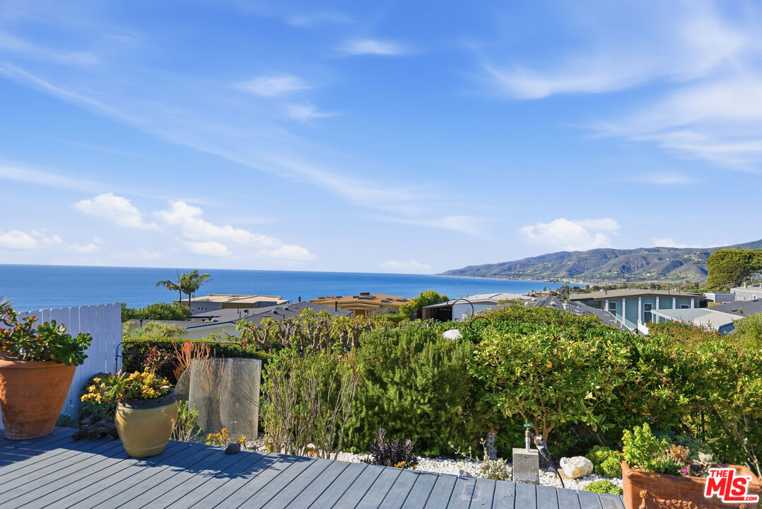 29500 Heathercliff Road, Unit 170 Malibu, CA 90265 - Photo 24 of 38 a view of a balcony with two chairs and a table