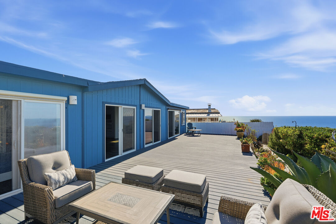 29500 Heathercliff Road, Unit 170 Malibu, CA 90265 - Photo 3 of 38 a terrace of a house with outdoor seating
