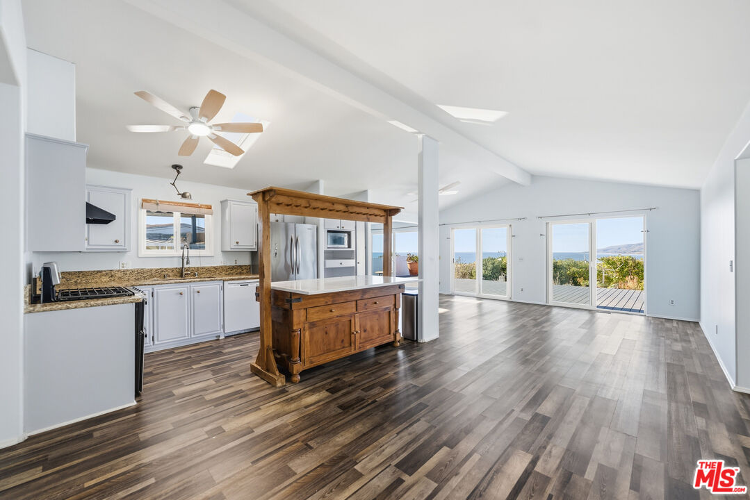 29500 Heathercliff Road, Unit 170 Malibu, CA 90265 - Photo 5 of 38 a kitchen with a wooden floor and window
