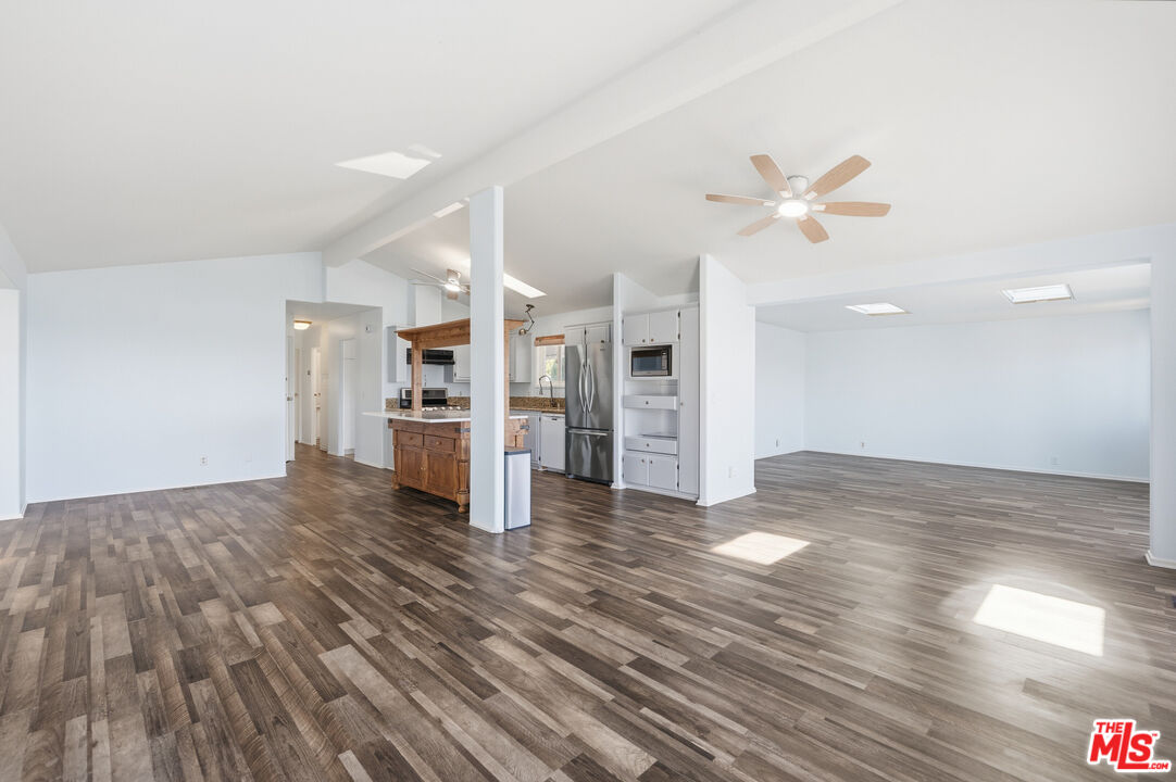 29500 Heathercliff Road, Unit 170 Malibu, CA 90265 - Photo 6 of 38 a view of a kitchen with wooden floor and a kitchen space with a sink