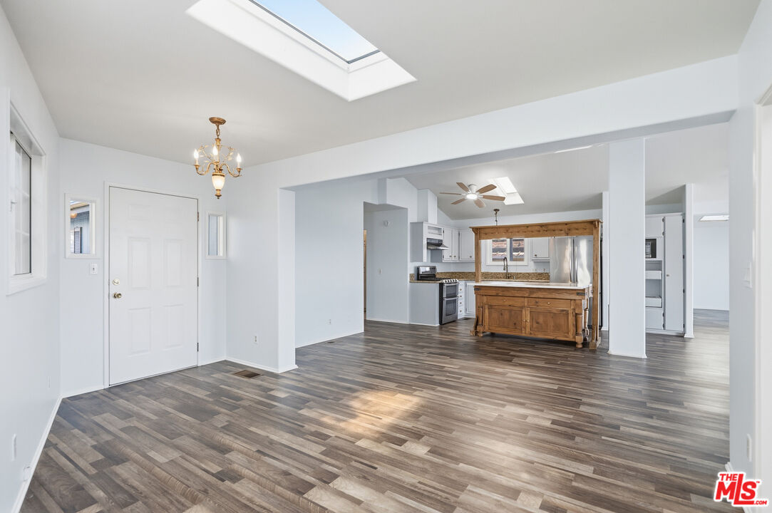 29500 Heathercliff Road, Unit 170 Malibu, CA 90265 - Photo 7 of 38 a view of a kitchen with a sink and dishwasher a refrigerator with wooden floor
