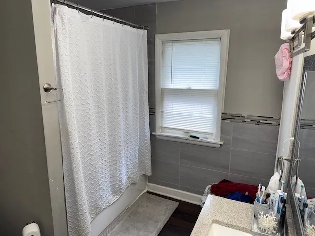 a bathroom with a bathtub and shower