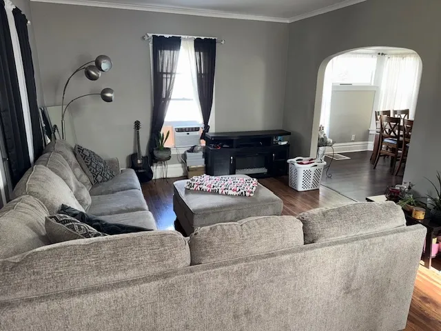 a living room with furniture and a large mirror