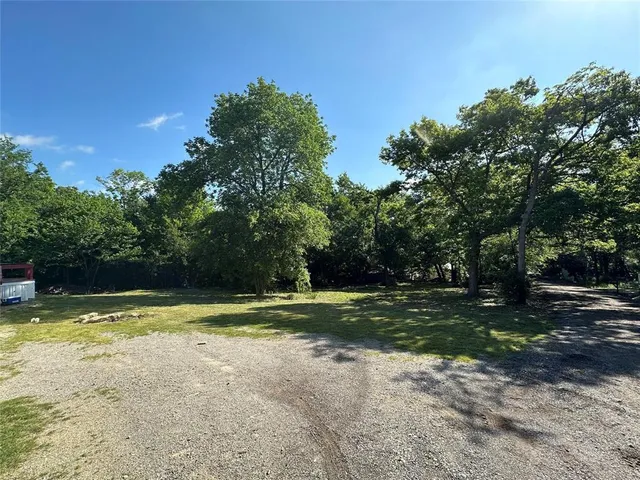 a view of a swimming pool and trees in the background