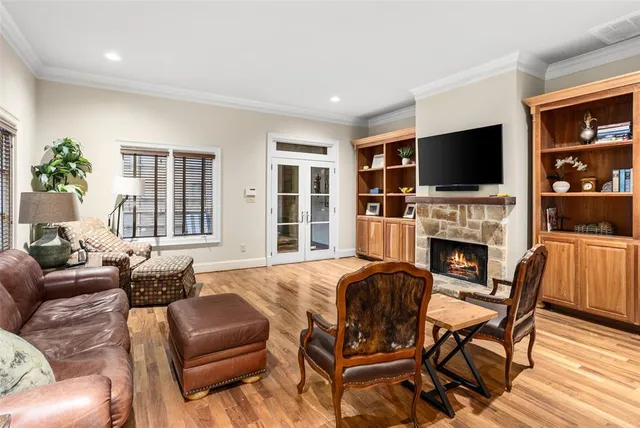 a living room with fireplace furniture and a flat screen tv