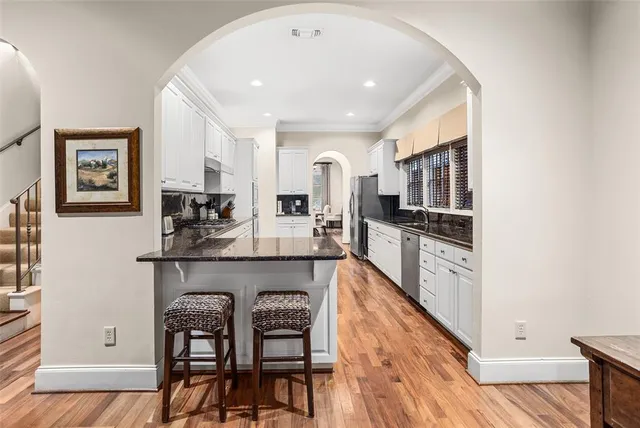 a large kitchen with stainless steel appliances granite countertop a stove and a refrigerator