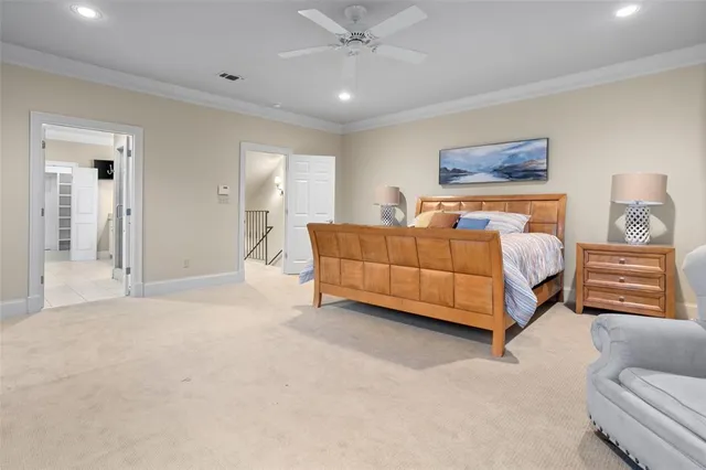 a spacious bedroom with a bed and ceiling fan