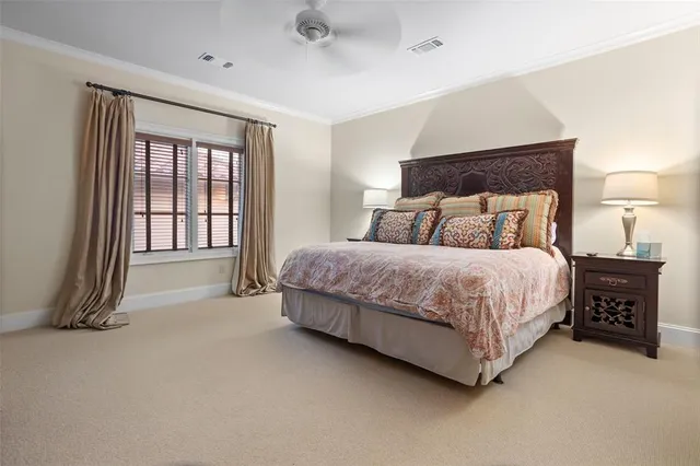 a spacious bedroom with a bed and a night stand