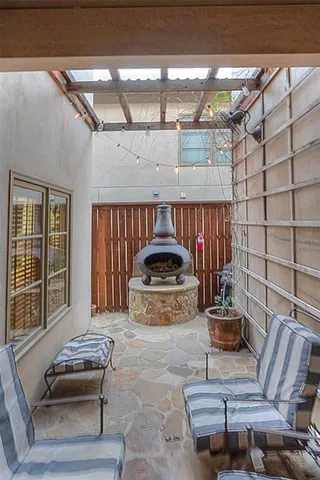 a living room with furniture a couch and a potted plant