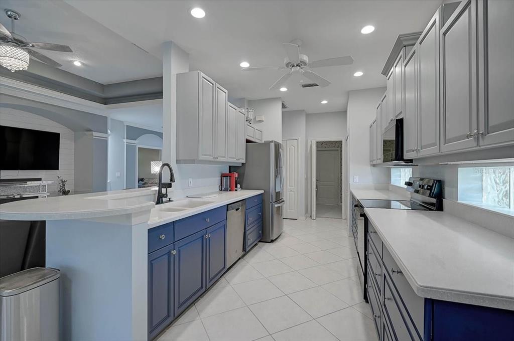 103 Bishopscourt Road Osprey, FL 34229 - Photo 11 of 55 a kitchen with kitchen island granite countertop a sink counter top space appliances and cabinets