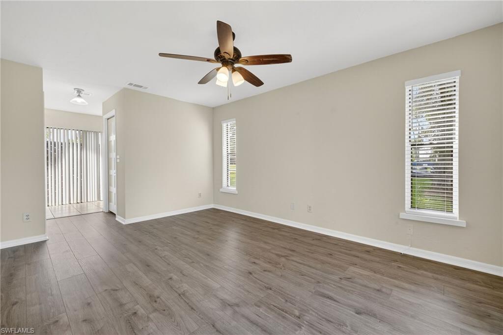 18294 Lee Road Fort Myers, FL 33967 - Photo 13 of 37 a view of an empty room with wooden floor and a window