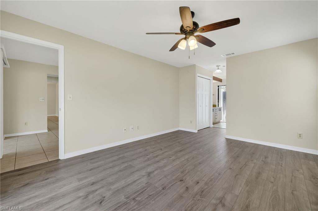18294 Lee Road Fort Myers, FL 33967 - Photo 14 of 37 an empty room with wooden floor ceiling fan and window