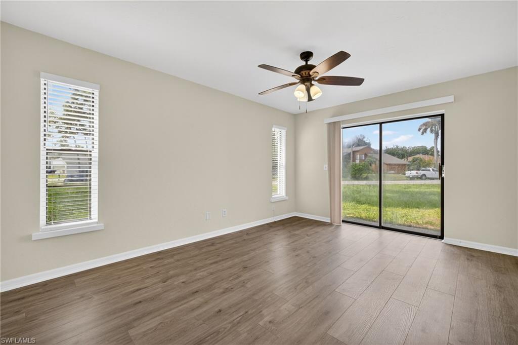 18294 Lee Road Fort Myers, FL 33967 - Photo 15 of 37 a view of an empty room with window and wooden floor