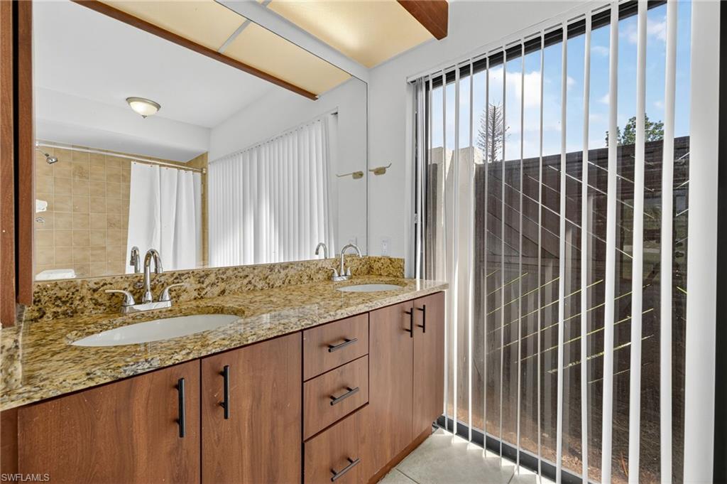 18294 Lee Road Fort Myers, FL 33967 - Photo 16 of 37 a bathroom with a granite countertop sink and a mirror