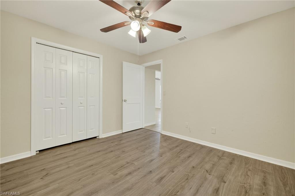 18294 Lee Road Fort Myers, FL 33967 - Photo 24 of 37 a view of an empty room with wooden floor