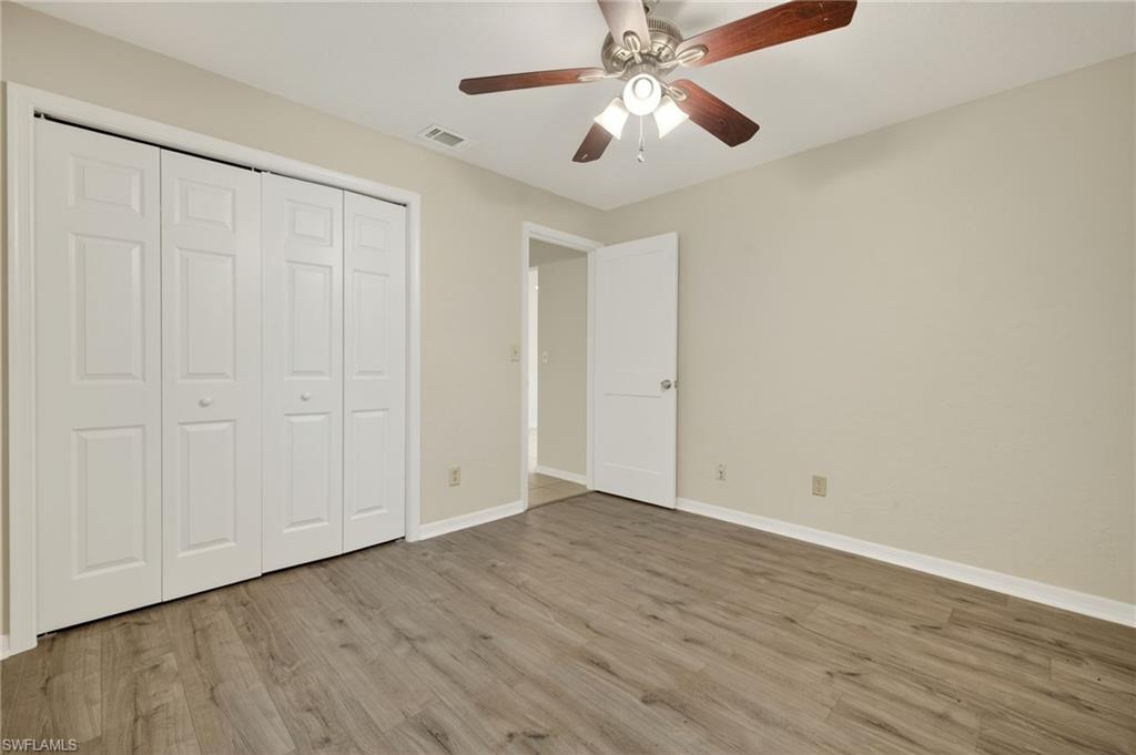 18294 Lee Road Fort Myers, FL 33967 - Photo 26 of 37 a view of an empty room with wooden floor