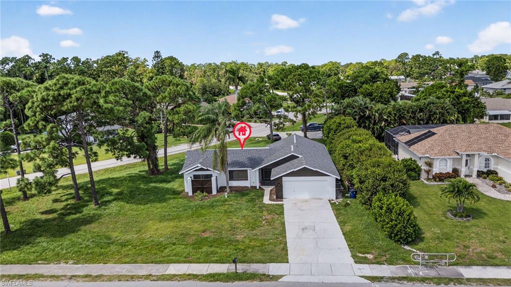 18294 Lee Road Fort Myers, FL 33967 - Photo 32 of 37 a front view of a house with a yard