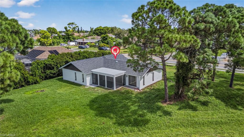 18294 Lee Road Fort Myers, FL 33967 - Photo 34 of 37 view of a house with a big yard plants and large trees