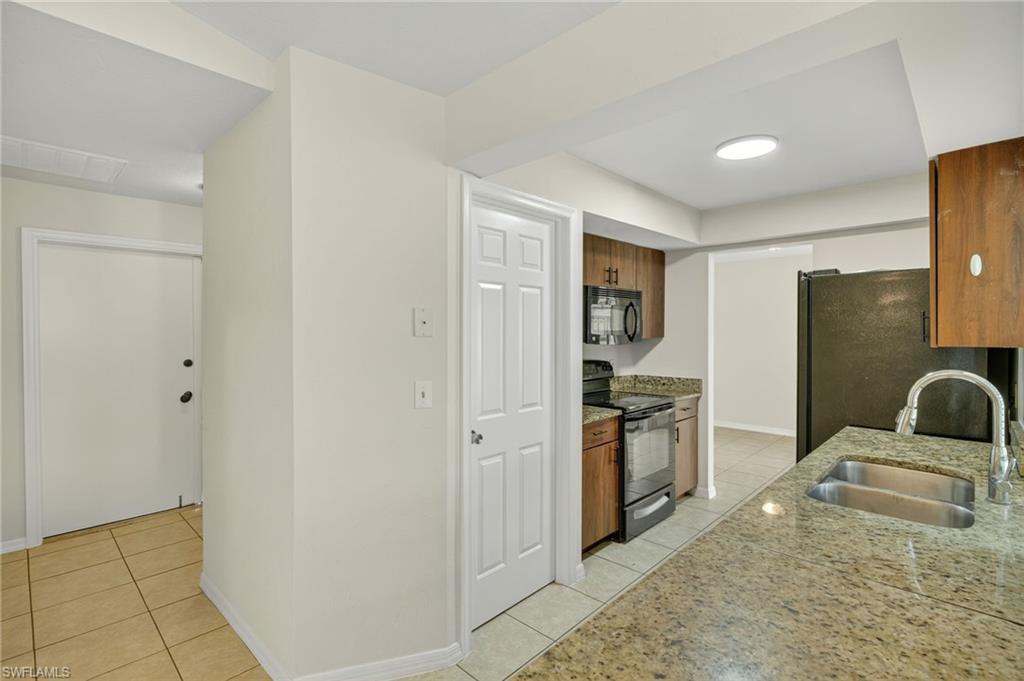 18294 Lee Road Fort Myers, FL 33967 - Photo 6 of 37 a kitchen with a refrigerator stove and a sink