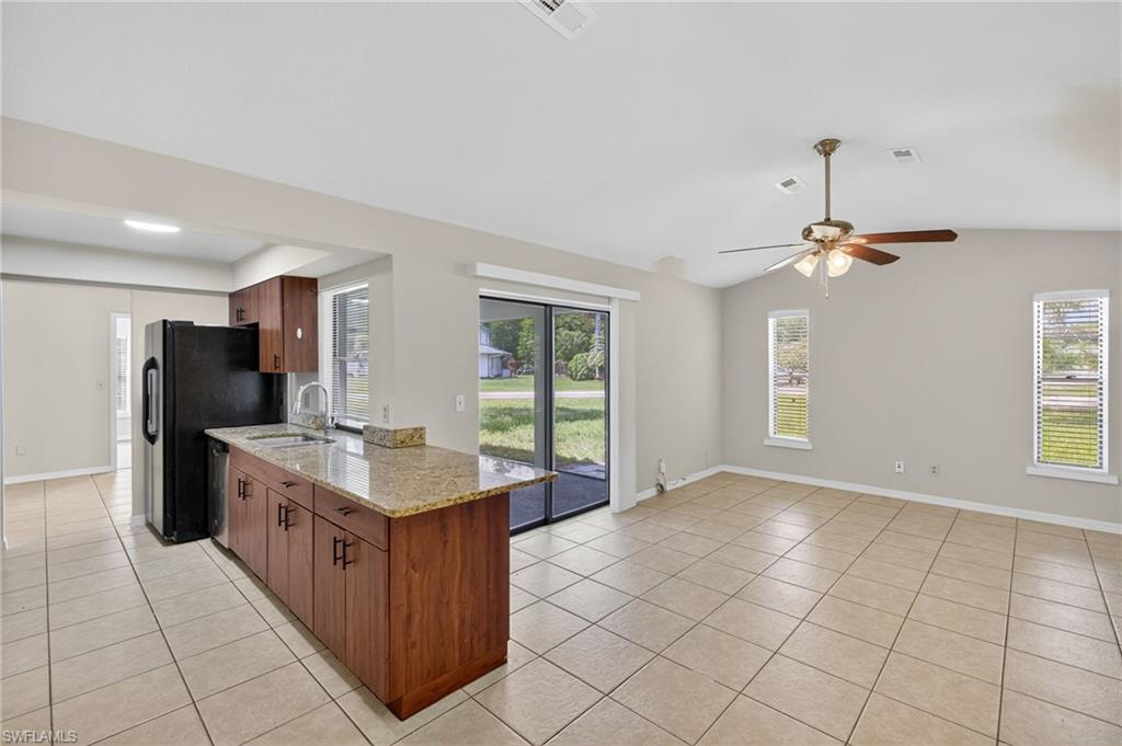 18294 Lee Road Fort Myers, FL 33967 - Photo 8 of 37 a kitchen with a sink a counter top space and stainless steel appliances