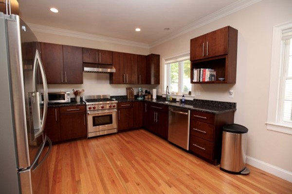 40 Hamilton Road Waltham, MA 02453 - Photo 5 of 30 a kitchen with stainless steel appliances granite countertop a stove a sink dishwasher and a refrigerator