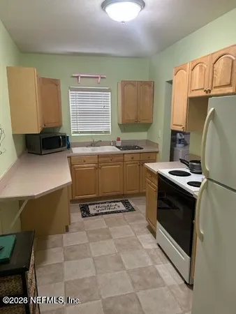 a kitchen with a sink and a stove top oven