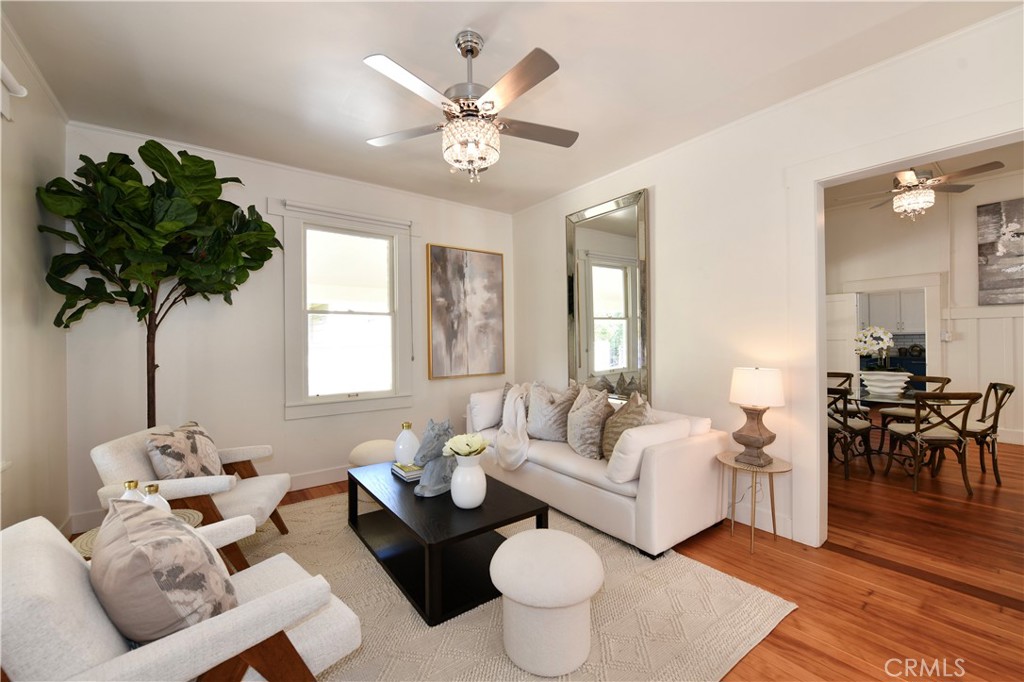 a living room with furniture potted plant and a chandelier