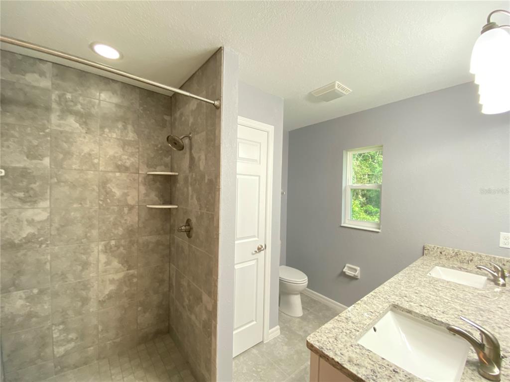 2827 Southwest 140th Loop Ocala, FL 34473 - Photo 15 of 29 a bathroom with a sink toilet and shower
