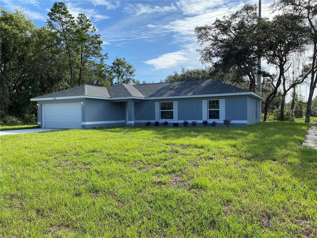 2827 Southwest 140th Loop Ocala, FL 34473 - Photo 2 of 29 a view of a house with a yard and a large tree