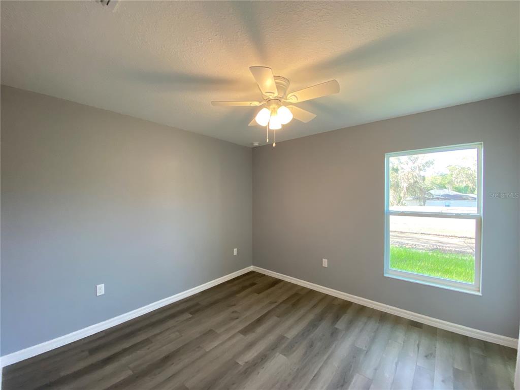 2827 Southwest 140th Loop Ocala, FL 34473 - Photo 22 of 29 an empty room with a window and a fan