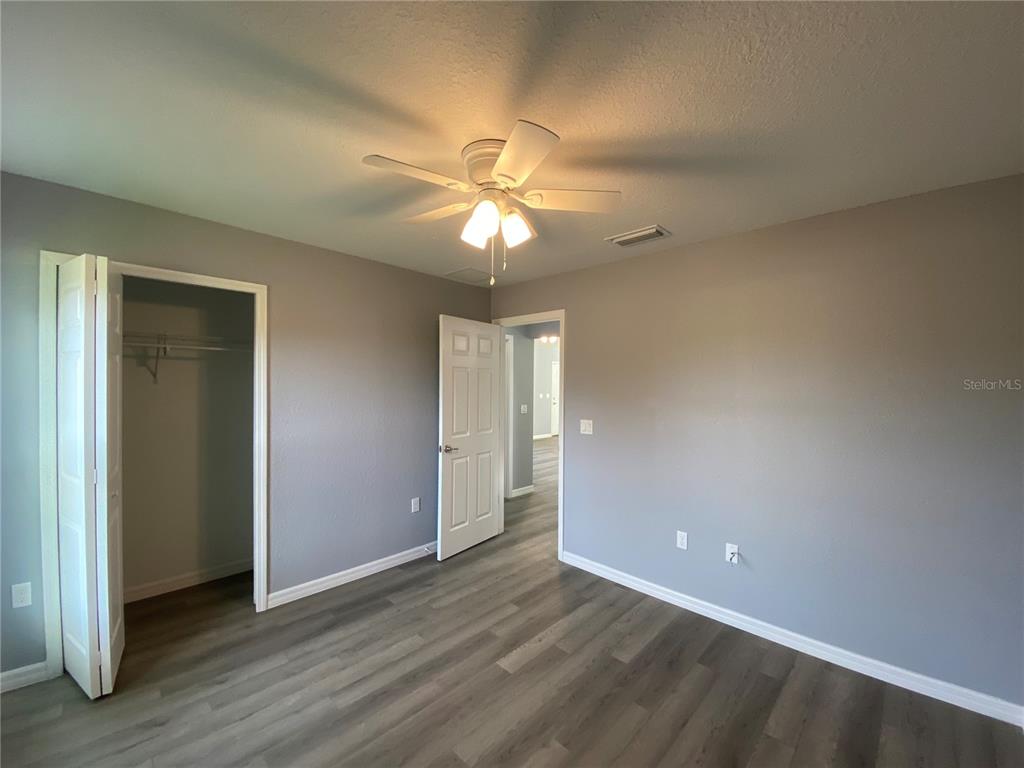 2827 Southwest 140th Loop Ocala, FL 34473 - Photo 23 of 29 an empty room with closet and a ceiling fan