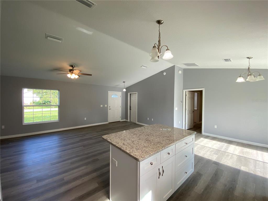 2827 Southwest 140th Loop Ocala, FL 34473 - Photo 9 of 29 an empty room with wooden floor and windows