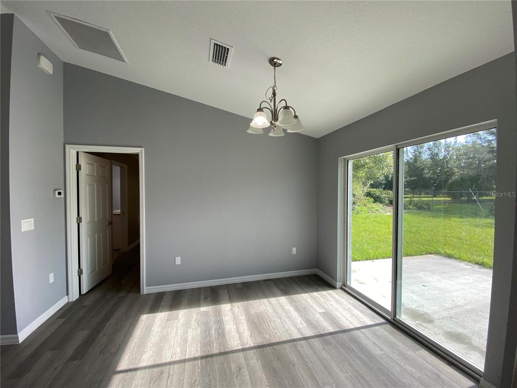 2827 Southwest 140th Loop Ocala, FL 34473 - Photo 10 of 29 a view of a room with wooden floor and windows